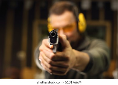 Shooting a gun at shooting range - Shutterstock ID 513176674