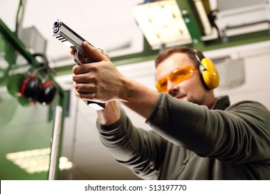 Shooting A Gun At A Shooting Range.