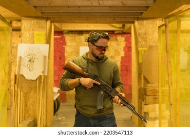 Shooting Instructor With An Old Ak 47 In A Shooting Range.