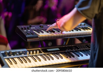 Сlose shooting of a keyboardist musician at work at a concert. Keyboardist play keyboard on stage. - Shutterstock ID 2095806610