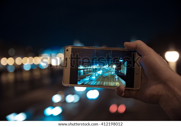 Shooting night\
Moscow city by smartphone in\
hand