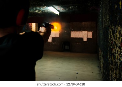Shooting A Pistol At Target In Indoor Firing Range Or Shooting Range