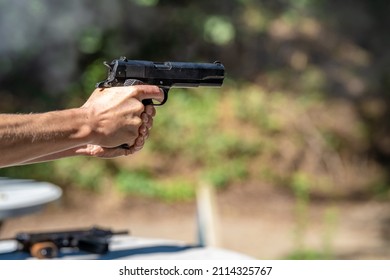 shooting from a pistol at a target on a shooting range