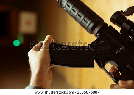 Shooting range client trying rental semiautomatic weapons, loading magazine, close up shot. Person reloading rifle ammo in firing range, sharpening skills, doing training