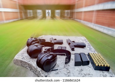 Shooting Range.
Gun , Bullets, Ear Plugs And Shooting Accessories On The Table At Shooting Range.