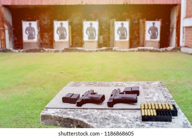 Shooting Range.
Gun, Bullets, Ear Plugs And Shooting Accessories On The Table At Shooting Range.