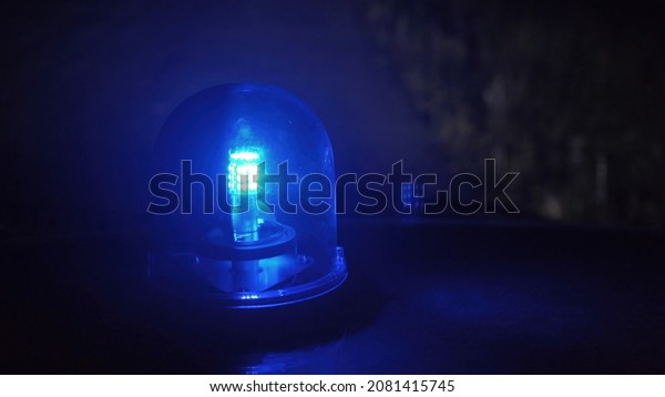 Shooting of\
rotating blue emergency light in the\
night