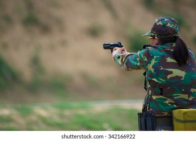 Shooting sports , female athletes ( Military) during shooting . The woman in the competition target shooting . 
