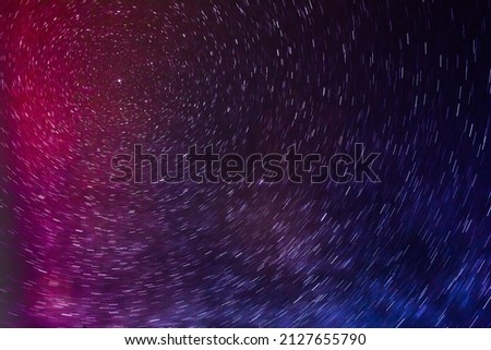 SHOOTING STARS SHINING IN THE NIGHT SKY AT COLORFUL POLAR LIGHTS
