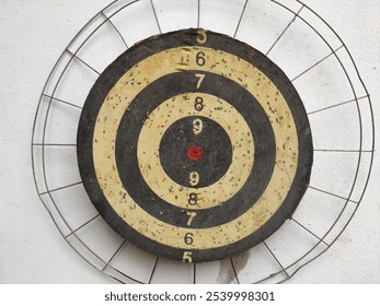 A shooting target featuring a classic design with faded numbers and a red center target. - Powered by Shutterstock