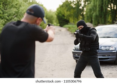 Shootout Between A Police Officer And A Offender. Stop Terrorism And Crime. The Police Officer And The Terrorist Are Aiming Each Other.