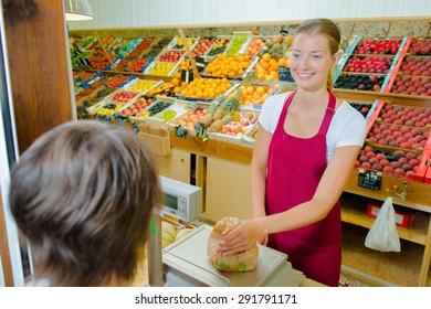 Shop Assistant Weighing Fruit