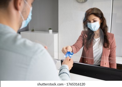 Shop Cashier In Store Or Hotel Reception With Medical Mask