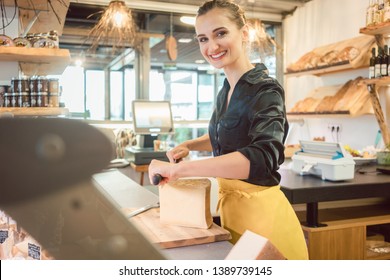 Shop Clerk Woman In Deli Cutting Cheese