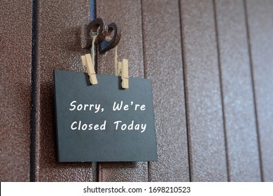 Shop close concept for business, website advertising and others. `Sorry, We're Closed today` text on the small board. - Shutterstock ID 1698210523