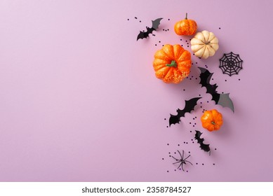 Shop eerie discounts: Top view shot displaying decorative pumpkins, spider, cobweb, bats and confetti on lilac context. Ad-friendly open area for content - Powered by Shutterstock