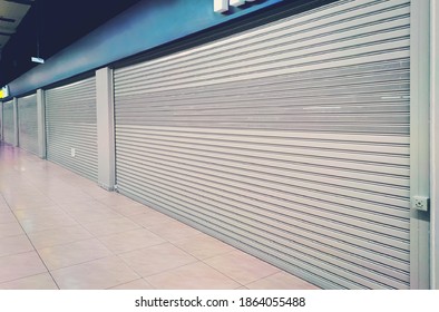 shop exterior with closed shutters. Small business problems during the coronavirus pandemic covid19. cafe is closed for quarantine due to covid 19 epidemic. shop window is closed by automatic gates.