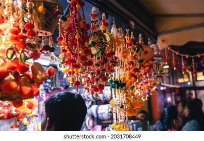 Shop with home decorative accessories for upcoming Hindu Diwali festival at a traditional fair. People at a night market in Indian city of Delhi, India. - Powered by Shutterstock