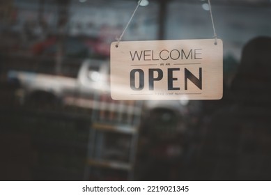 Shop opening sign at the glass door in vintage tones. - Shutterstock ID 2219021345