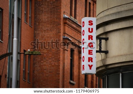 Shop Surgery symbol in Dublin, Ireland. Red bricks building in the background