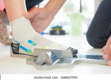 A Shop Worker Measuring Foot Size