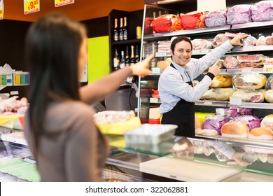 Shopkeeper Serving A Customer In A Grocery Store 