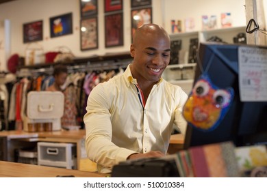 Shopkeeper Using Computer In Vintage Shop