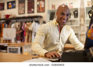 Shopkeeper Using Computer In Vintage Shop