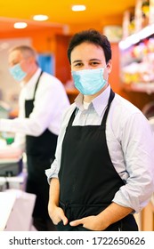 Shopkeeper Working In His Grocery Store Wearing A Mask, Coronavirus Concept