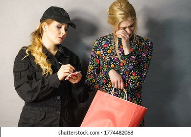 Shoplifting Is A Crime. Teenage Girl Being Caught On Stealing Clothes By Female Security Guard. Customer Thief