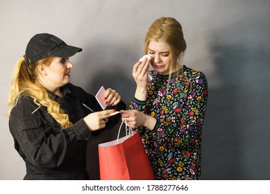 Shoplifting Is A Crime. Teenage Girl Being Caught On Stealing Clothes By Female Security Guard. Customer Thief