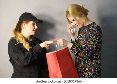 Shoplifting Is A Crime. Teenage Girl Being Caught On Stealing Clothes By Female Security Guard. Customer Thief