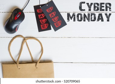 shopper with cyber monday paperbag, PC mouse, laptop. ticket label Sale tag - online shopping concept