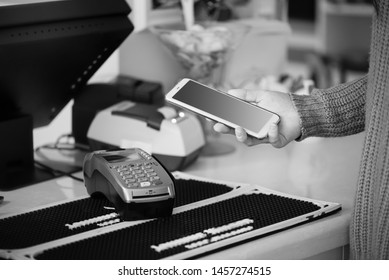 Shopper does payment using smartphone. NFC technology in people life.