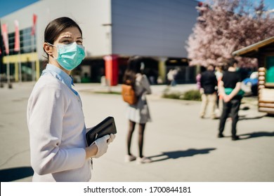 Shopper with mask standing in line  to buy groceries due to coronavirus pandemic in grocery store.COVID-19 shopping safety measures,social distancing.Quarantine preparation.Panic buying.Long queue - Shutterstock ID 1700844181