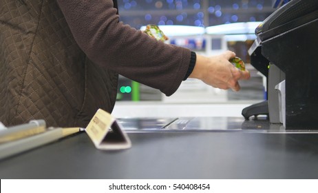 Shopper Paying For Products At Checkout. Foods On Conveyor Belt At The Supermarket. Cash Desk With Cashier And Terminal In Hypermarket. Working Of Cashier. Shopping At Store. Close Up