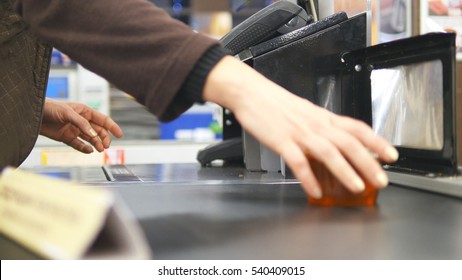 Shopper Paying For Products At Checkout. Foods On Conveyor Belt At The Supermarket. Cash Desk With Cashier And Terminal In Hypermarket. Working Of Cashier. Shopping At Store. Close Up