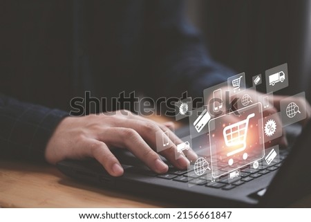 Shopper using computer laptop to input order with trolley credit card delivery truck for online shopping and e-commerce technology concept.