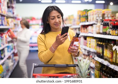 Shopper Using Smartphone Scans Qr Code On Label In Grocery Supermarket