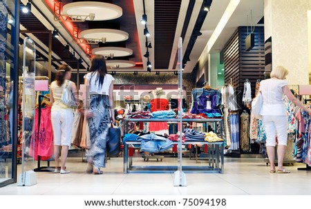 Shoppers at shopping center, motion blur