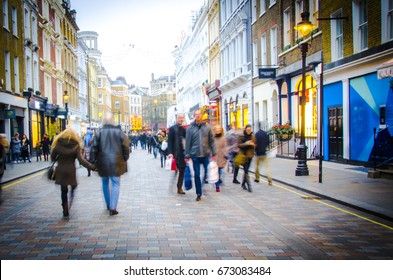 Shoppers walk down busy central London High Street 