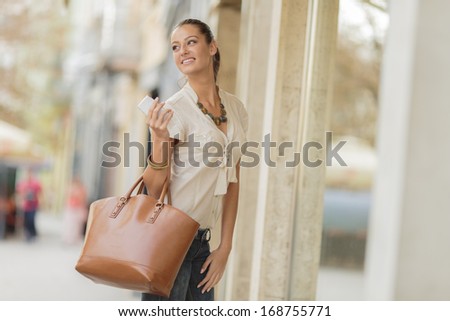 Similar – Image, Stock Photo Smiling woman with handbag standing by colorful background