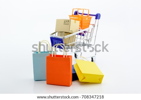 Shopping addiction, shopping lover or shopaholic concept : Paper boxes / cartons and small toy shopping cart, on white background. Many people / consumers or buyers addicted to buy unnecessary things. Foto d'archivio © 