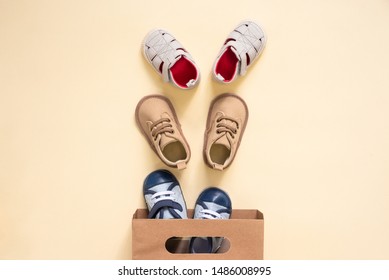 Shopping Bag And Baby Boots On An Orange Background.