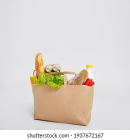 Shopping Bag Full Of Products Over White Background With Copy Space