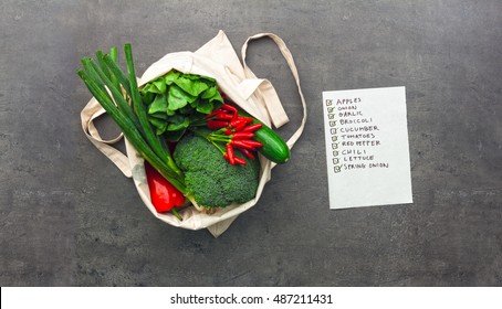 Shopping Bag Full Of Vegetables And Fruits With Checked Shopping List. Flat Lay Food On Table.