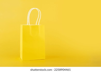 shopping bag on yellow background, copy space, monochrome,one color  - Shutterstock ID 2258904461