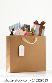 Shopping Bag of presents on white table.  brown Shopping bag. 
