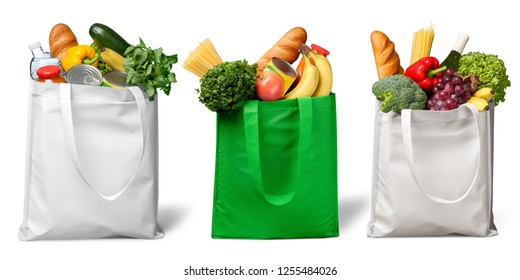 Shopping bags with groceries isolated on white