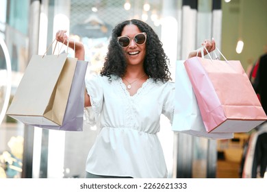 Shopping bags, happy and woman with sunglasses in the city for a sale, discount or promotion. Happiness, smile and portrait of female customer enjoying retail fashion shop spree in the street in town